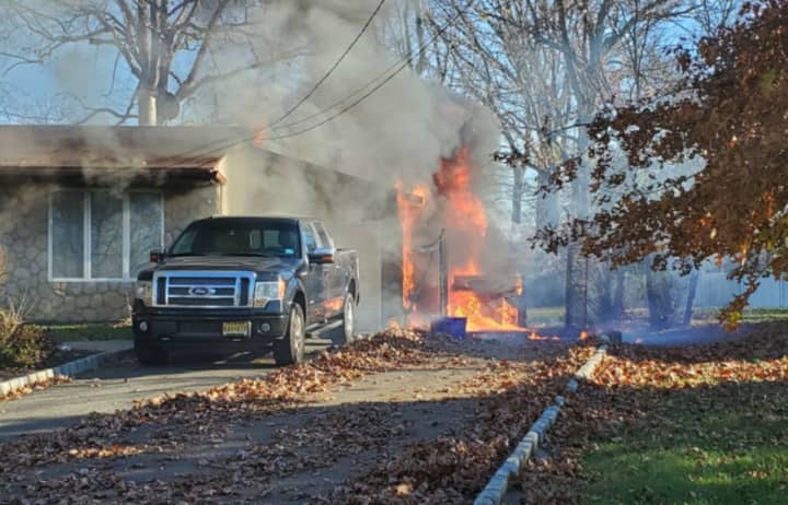 A lawn mower fire spread to a nearby propane grill, consuming a South Brunswick home Friday.