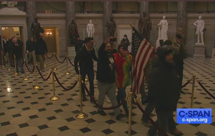 Rioters in the rotunda of the Capitol.