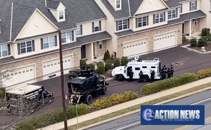 Footage from 6abc Action News shows armored vehicles at a home on Johnson Road and Germantown Pike around 10:45 a.m.