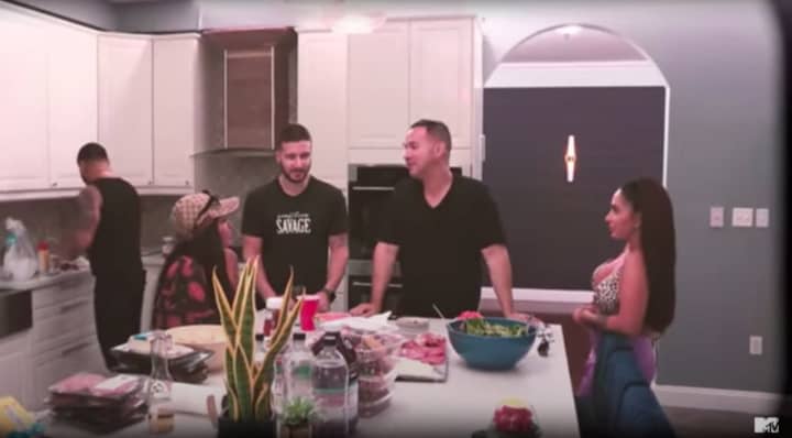 &quot;Jersey Shore&quot; cast members gather around the kitchen island in the Manalapan home where &quot;Jersey Shore Family Vacation&quot; was filmed.