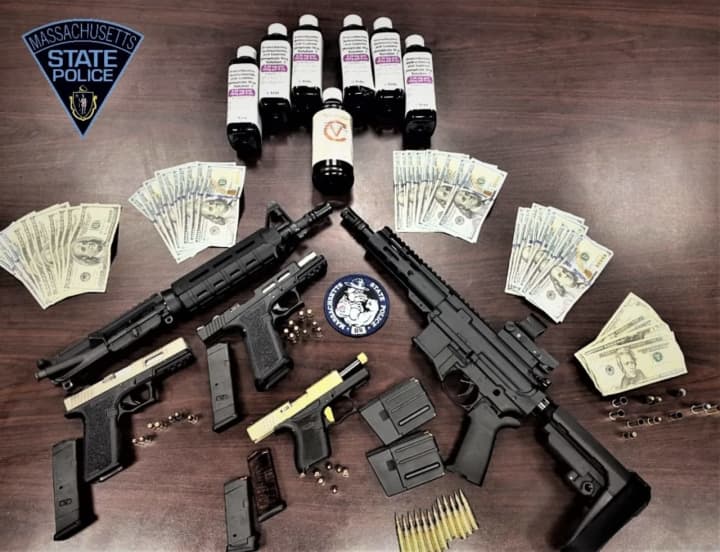 Massachusetts State Police seized weapons, drugs, and cash during a traffic stop.