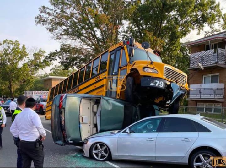 Ten people suffered minor injuries in a three-car crash that ended with a school bus on top of another vehicle Tuesday morning in Ocean County, first reported by The Lakewood Scoop.
