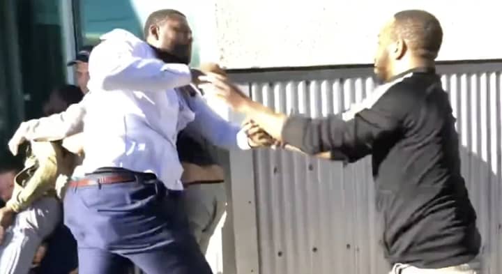 Republican candidate for congress Donnie Palmer, left, fights with a man outside of an event for his opponent, Rep. Ayanna Pressley, outside the Somerville Theatre on Saturday, Sept. 24.