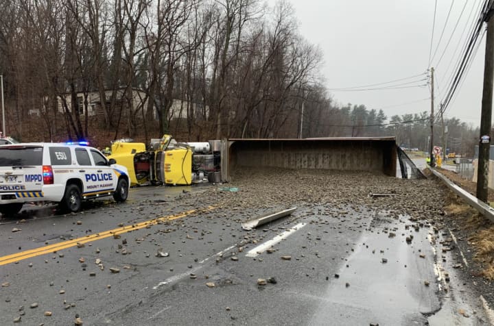 An overturned truck spilled a load of small stones on Route 9A in Hawthorne, causing the road to close for several hours.