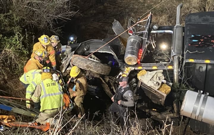 First responders from multiple rescue squads worked feverishly to free an entrapped truck driver from his smashed cab in a Readington crash.
