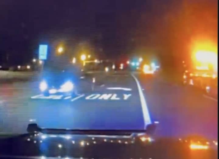 Police dashcam video shows a drunk driver in a BMW headed the wrong way on a highway at a police car.