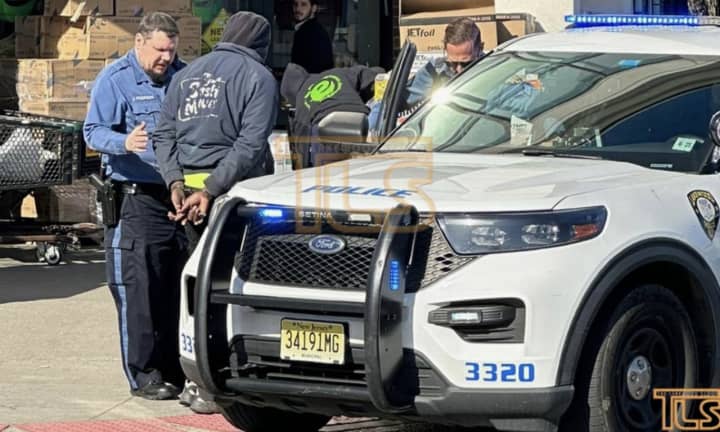 Lakewood police take delivery truck driver Christopher Borker into custody. (Photo courtesy of The Lakewood Scoop)