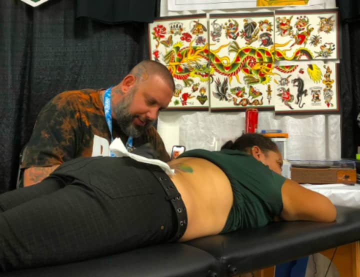 Robert Kinzel, owner of R&amp;B Tattooing and Dominion Piercing, at work.