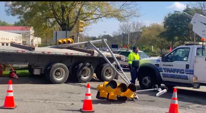 An elongated tractor trailer took down a traffic control signal in a tight turn at a Paramus intersection Tuesday, Oct. 10.