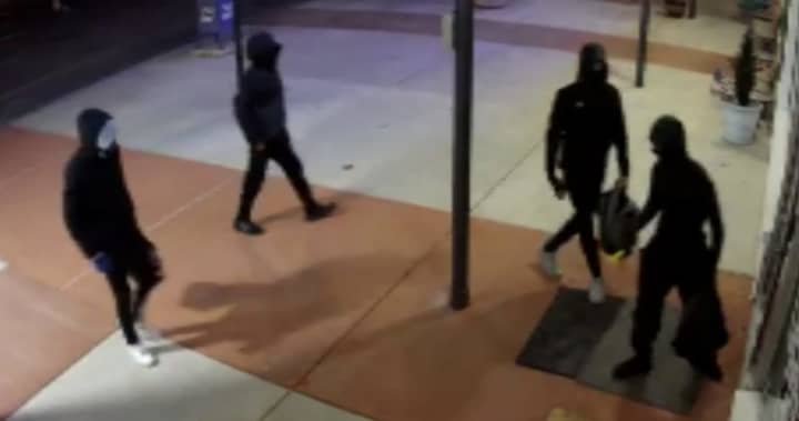 A surveillance camera caught video of four burglary suspects outside Urban Tactical Firearms.