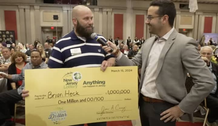 Brian Heck with his ceremonial $1 million New Jersey Lottery check.