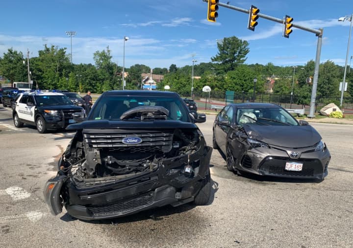 Two people were injured and the front end of an Auburn Police cruiser was badly damaged in a Monday, Aug. 3, accident in Auburn.