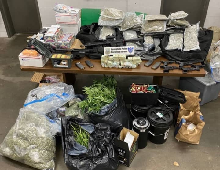 Springfield Police confiscated pounds of marijuana and scads of firearms after a structure fire revealed an illegal marijuana grow operation.