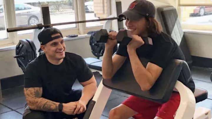 Jesse Setaro, left, works with a client at one of his gyms in Boston. Setaro, who grew up in the foster care system, is raising money to start a gym for foster, where they can learn about fitness and how to run a business. He calls it Project F.