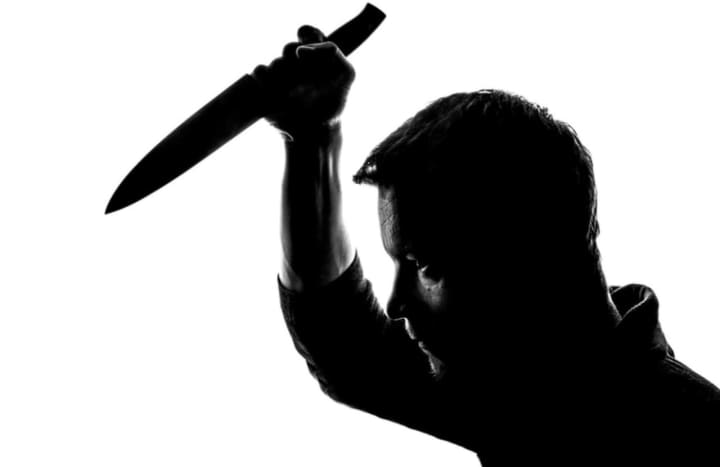 A stock image of a man holding a knife.