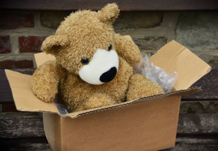 A stuffed bear in a box.