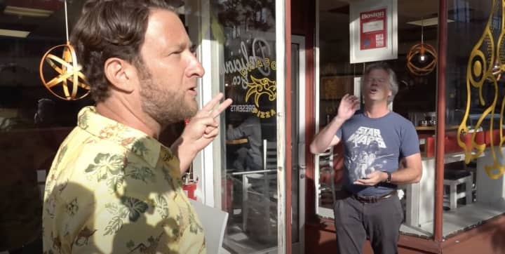 Dragon Pizza owner Charlie Redd, right, argues with Barstool Sports President Dave Portnoy during a viral "One Bite Pizza Review" last year.&nbsp;