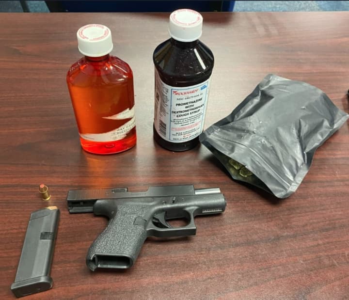 Loaded .38 caliber Glock handgun and two bottles of suspected promethazine/codeine recovered at the scene
