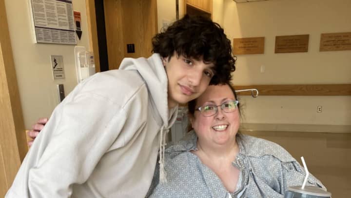 Kathy Mestas poses with a friend at the hospital, where she is undergoing chemotherapy and radiation treatments for cancer.&nbsp;