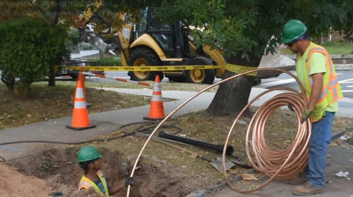 Workers replace water lines containing lead in Newark. The city has launched an ambitious plan to replace 18,000 lines within three years at no cost to homeowners or landlords.