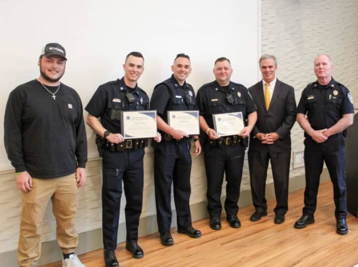 From left: Justin Schmautz and his rescuers Shrewsbury officers Tyler Vlass and Dillon Zona and Sgt. Mark Sklut, along with Worcester County District Attorney Joseph D. Early Jr. and Shrewsbury Police Chief Kevin Anderson, during the TEAM Award.