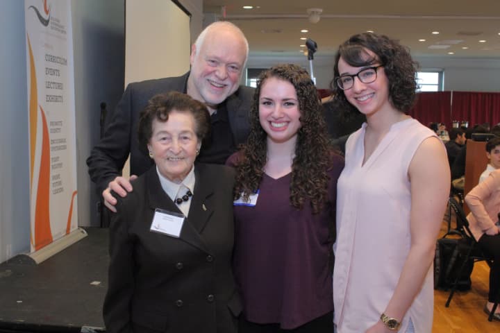 Judy Altmann, Neil Ginsberg, and teacher Stephanie Catania surround Somers High School student Emily Schreer (middle) at the 15th annual Human Rights Institute for High School Student Leaders.