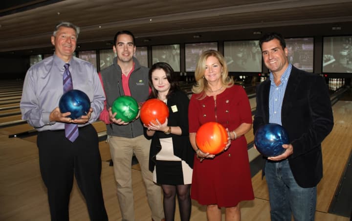 From left, Kenneth Schmitt, Frank Smith, Erin Meagher, MaryEllen Odell and Bill Diamond pose with bowling balls at the recent grand reopening of Spins Bowl Carmel.