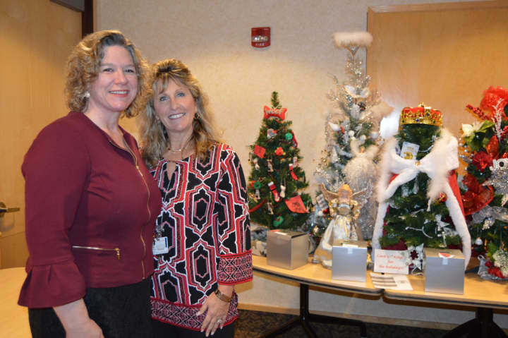 Susan Agamy, executive director of Spooner House, left, joins Kim Hall, senior applications coordinator at Griffin Hospital, and hospital staff in drawing tickets for the Holiday Wonderland of Trees last month.