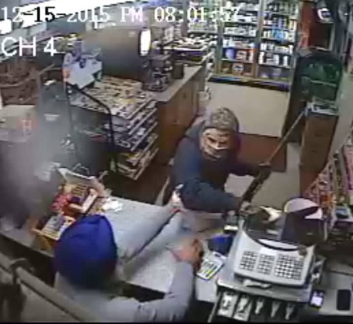 Surveillance footage of the struggle between the robber and the gas station clerk. 