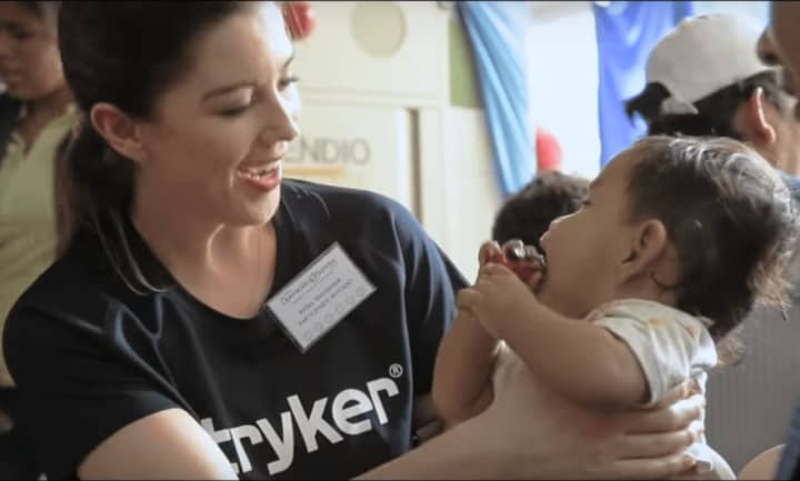 A Stryker employee volunteers with Operation Smile.