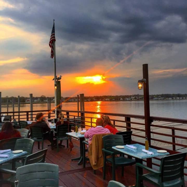 Patrons linger over their meals and cocktails at the Sunset Grill in Norwalk, located on Long Island Sound at the mouth of the Norwalk River.
