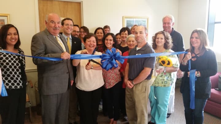 Susan Balamaci cuts the ribbon for her new business in Mount Kisco.
