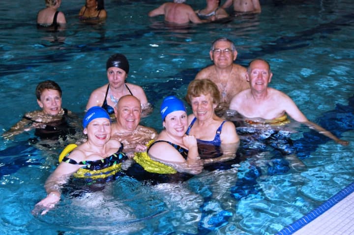 NCJW volunteers and swimmers (individuals with multiple sclerosis) take part in therapeutic exercise in the JCC pool.