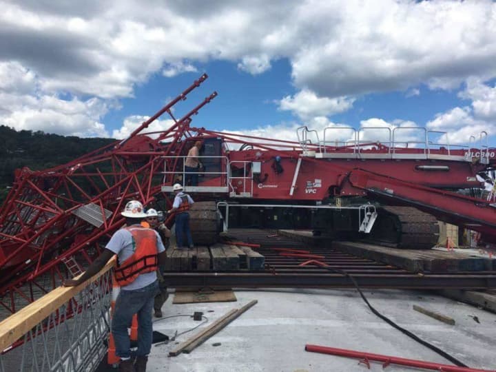 The boom of a crane working on the new bridge collapsed across the existing Tappan Zee Bridge on Tuesday.