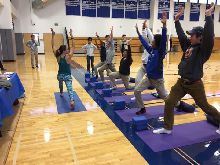 Talita Moss teaching students yoga at Darien High School&#x27;s recent health fair.