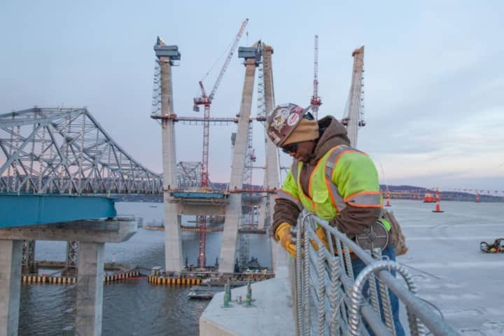An ironworker ties steel reinforcement for a concrete barrier on the new Tappan Zee Bridge on Tuesday, Dec. 13. Construction work will be suspended over the New Year&#x27;s weekend to aid holiday travelers.