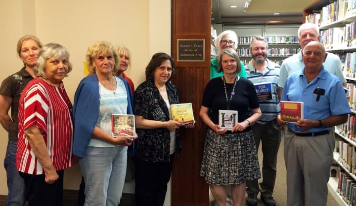 The Kent Library Board gathers in the Dolores F. Kraus Memorial Audiobook Area.