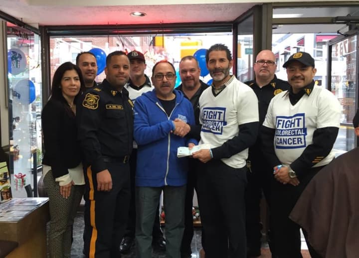 Bob Ceragno shakes hands with Public Safety Commissioner Allen Pascual near the end of the shave-off event at his store, following the North Bergen PBA&#x27;s &quot;No Shave November&quot; fundraising this past fall.