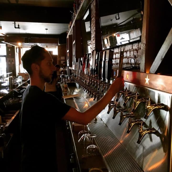 A bartender downloads some microbrew from one of the 90 taps at The Shepherd &amp; The Knucklehead in Haledon.