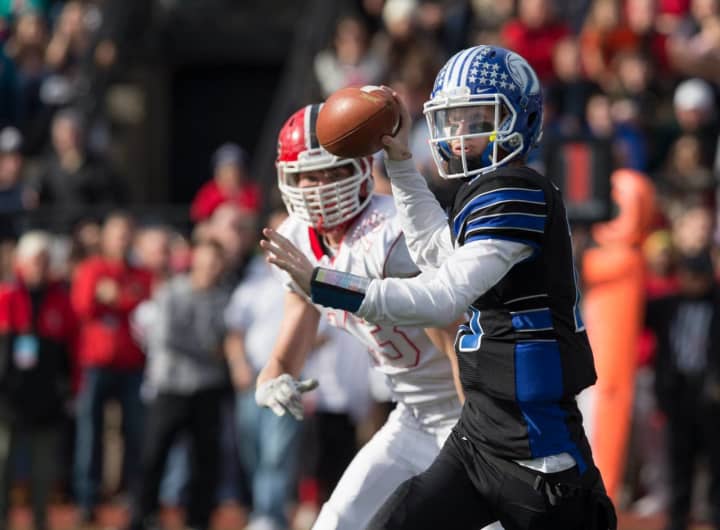 Darien quarterback Timmy Graham leads the Blue Wave over New Canaan on Thanksgiving. 