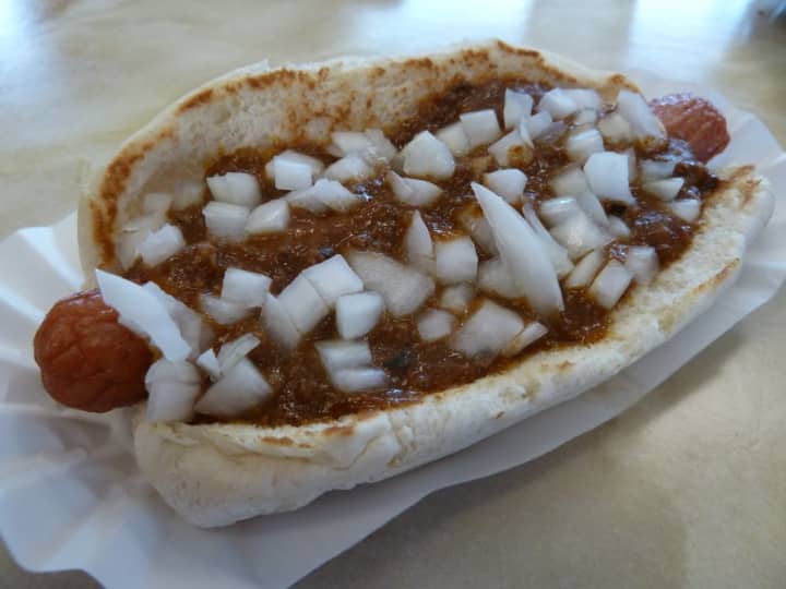 One of Tomlinson&#x27;s dogs smothered in chili and topped with fresh onions.