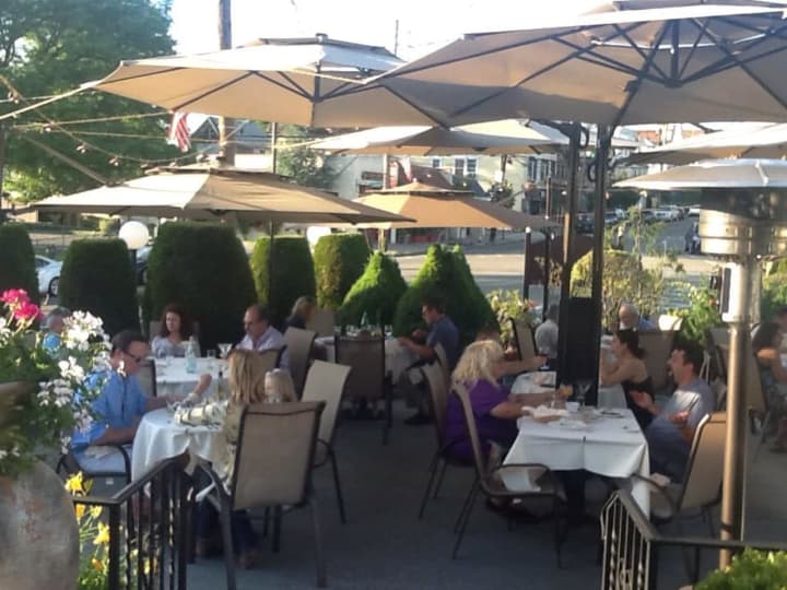 White tablecloths and umbrellas enhance the outdoor dining experience at Toscana Ristorante in Tuckahoe.