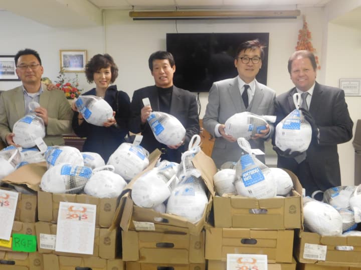 Leem&#x27;s Corporation officials and Mayor James Rotundo, far right, distribute turkeys to seniors in Palisades Park on Monday.