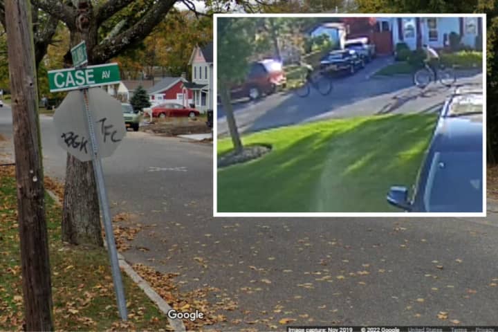 Suffolk County Police need help identifying two people seen damaging a Pride flag at a home on Case Avenue in Patchogue in May 2022.