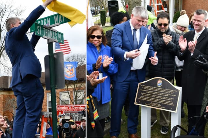 Malverne Mayor Keith Corbett unveils the newly renamed Acorn Way during a ceremony held outside Maurice Downing Elementary School on Thursday, Jan. 26.