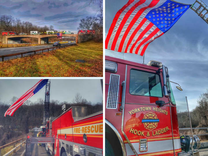 Members of the Yorktown Heights Fire Department and several other organizations stood over the Taconic State Parkway to honor the procession carrying fallen officer Kenneth Sgroi to his hometown.