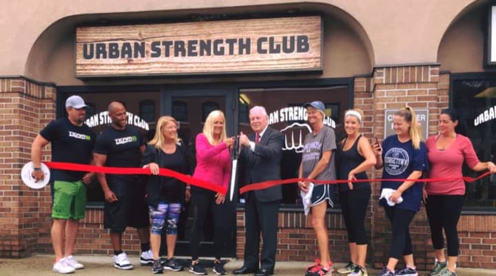 Owner Debbie O&#x27;Toole, center, and Fairfield First Selectman Mike Tetreau cut the ribbon at Urban Strength Club on Kings Highway East.