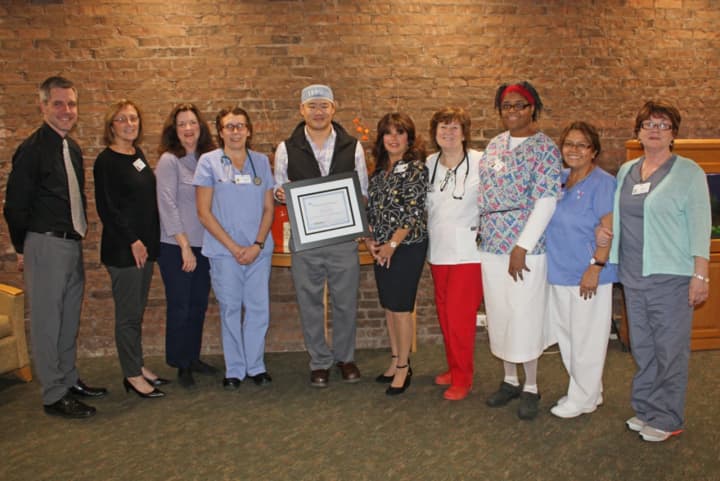 Brad Sherwood, Regional Director of Business Development for VOHRA Post-Acute Physicians, Dr. Dennis Ng and members of Waveny Care Center’s clinical team with an award naming Waveny a Certified Center of Excellence for Wound Care.