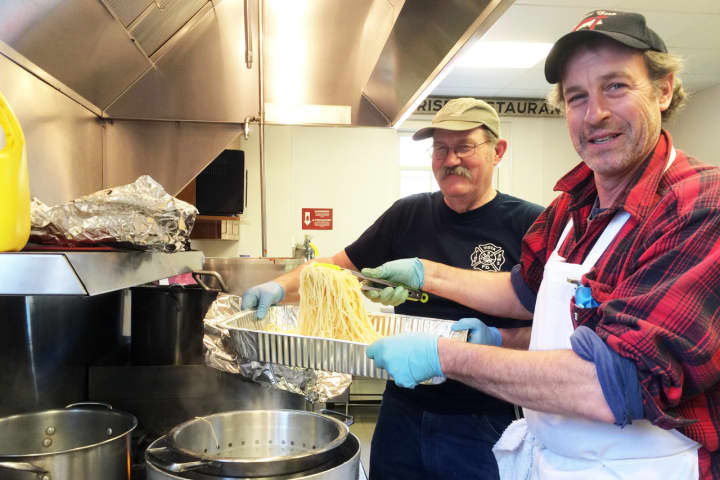 Volunteers Jim Hackett, left, and Joe Haberny cook at the Vista Fire Department&#x27;s second annual Spaghetti Dinner.