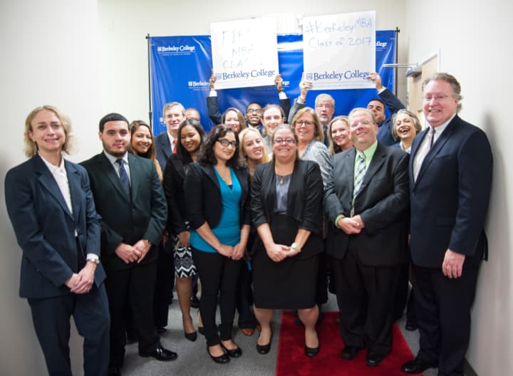 Graduate students in the inaugural class of the MBA in Management program at Berkeley College in the new School of Graduate Studies celebrate with college President Michael J. Smith